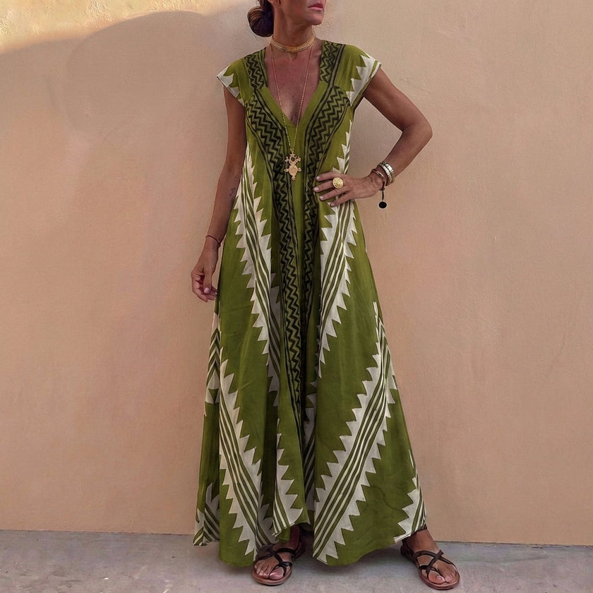 Light green bohemian-inspired flowing A-line maxi dress with deep V-neck and geometric motifs by FJØRNA.