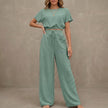 Light green Coastal Breeze textured two-piece lounge set with wide-leg pants by FJØRNA, casual and comfortable for relaxed wear.