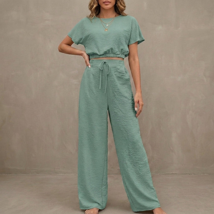 Light green Coastal Breeze textured two-piece lounge set with wide-leg pants by FJØRNA, casual and comfortable for relaxed wear.