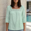 Light green FJØRNA summer women’s blouse with square neckline and lace details, stylish top for warm weather.