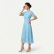 Light blue FJØRNA women's lace midi dress with high neck and cutwork detail, shown from a 3/4 side front view.