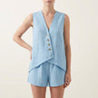 Light blue FJØRNA relaxed sleeveless V-neck two-piece set with asymmetrical button front, featuring a stylish and comfortable design.