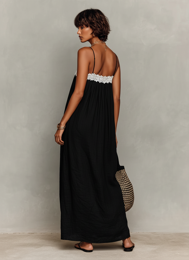 FJØRNA linen strapless maxi evening dress displayed on a hanger, featuring flowing fabric and elegant design.