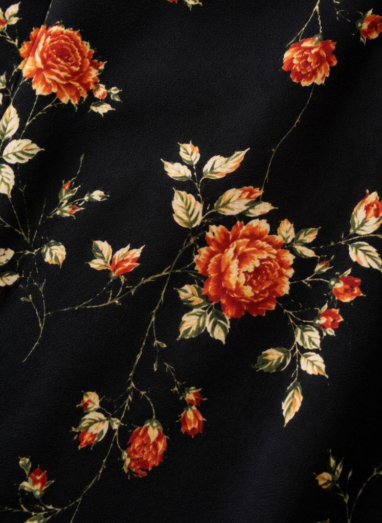 Women's floral midi dress by FJØRNA with button front, short sleeves, and a feminine, flowy design.
