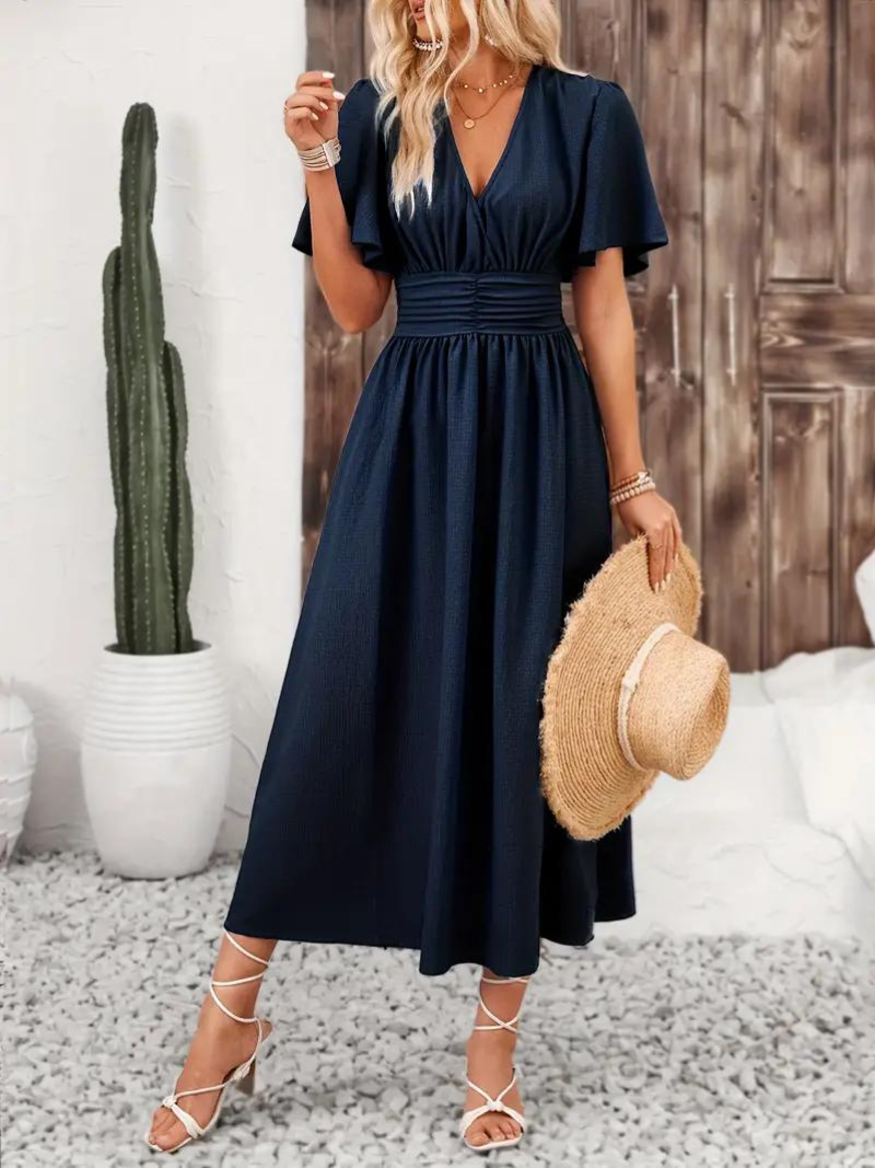 FJØRNA Arielle white long dress with short sleeves and V-neck, flowing maxi sundress perfect for summer wear.