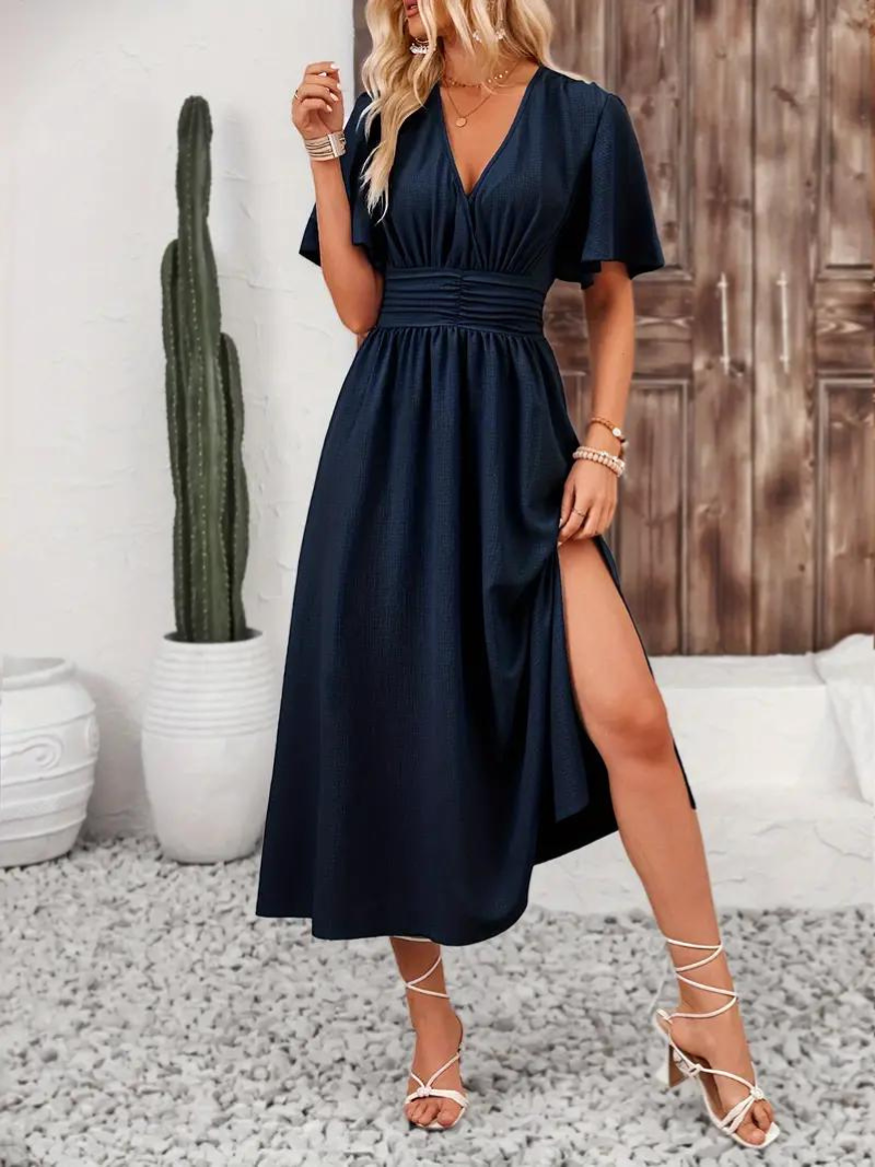 FJØRNA Arielle white long sundress with short sleeves and V-neck, perfect for summer, flowing maxi dress style.