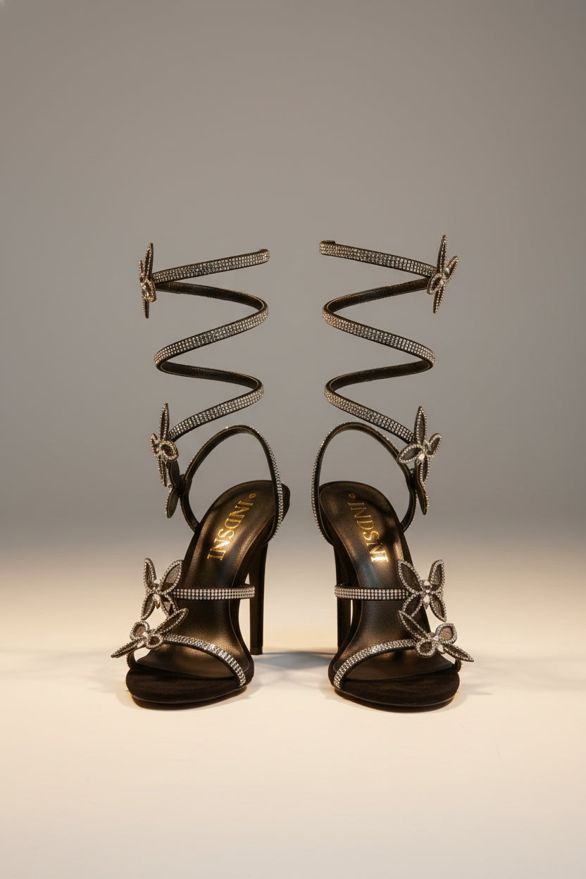 FJØRNA women's stiletto sandals with butterfly wrap design, rhinestones, and heeled style, featuring elegant, open-toe footwear.