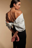 FJØRNA Ava off-shoulder midi dress in white with sculpted monochrome details, stylish and elegant for special occasions.