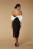FJØRNA Ava off-shoulder midi dress with sculpted monochrome detail in white, displayed on a model.
