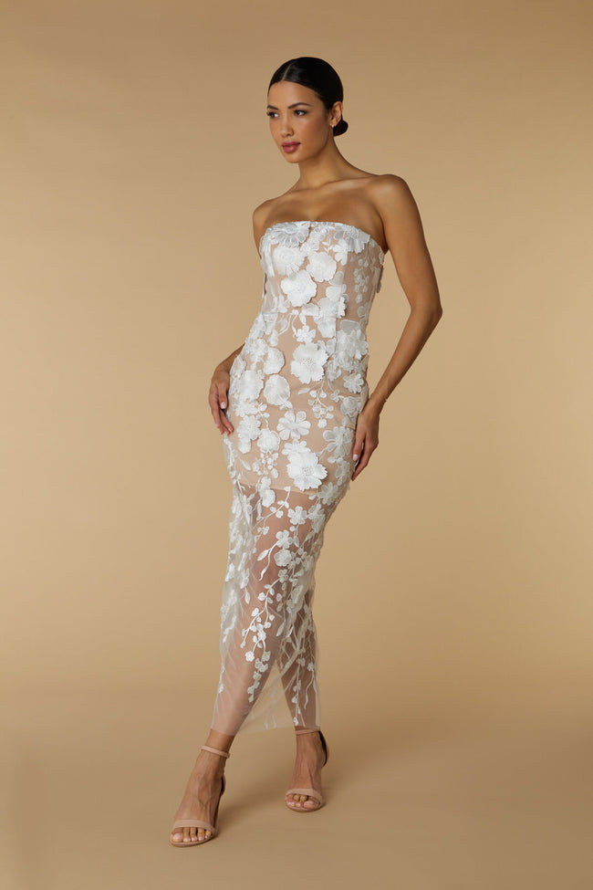 FJØRNA Willow strapless midi dress in ivory with floral 3D lace, showcasing a fitted bodice and flowing skirt.