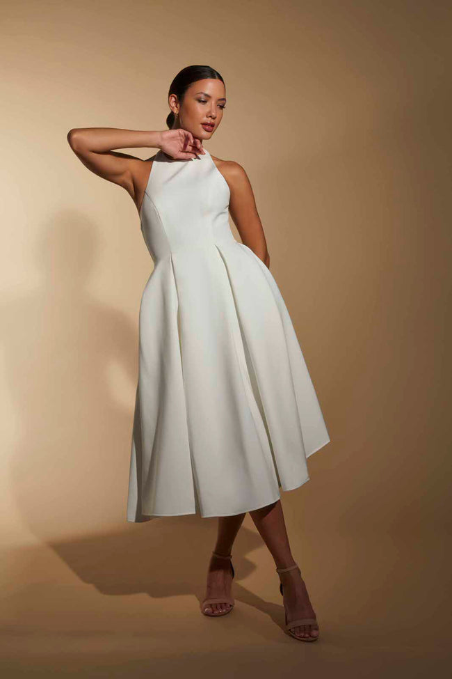 FJØRNA white midi dress with halter neckline, elegant sleeveless design, perfect for summer or formal occasions.