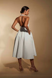 FJØRNA ivory line midi dress with halter neckline, sleeveless design, and elegant fit, perfect for summer or formal occasions.