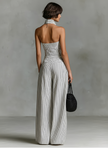 FJØRNA striped linen sleeveless jumpsuit for women with single-breasted design and V-neck, featuring pants style and casual chic look.