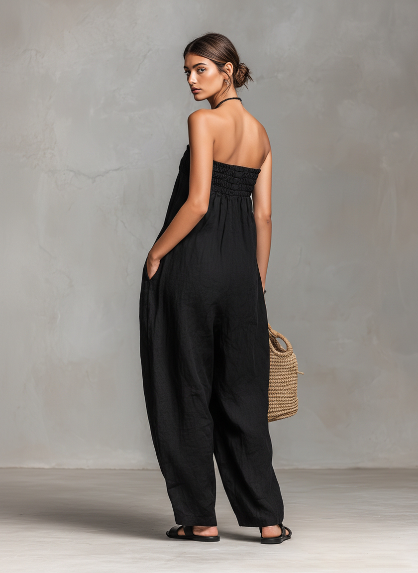 Women’s linen blend strapless jumpsuit by FJØRNA featuring a loose-fit design and tie closure, displayed on a mannequin.