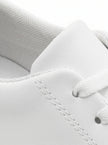 Close-up of men's white slip-on trainers by FJØRNA, showcasing minimalist design and clean casual style.
