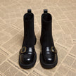 FJØRNA women's orthopedic ankle boots with buckle detail and arch support, stylish footwear designed for comfort and stability.