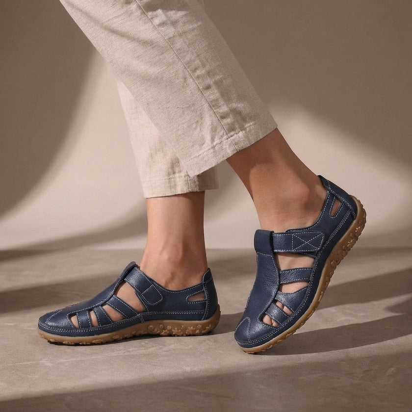 Marine blue FJØRNA orthopedic closed-toe sandals with cutout details and a comfortable fit, designed for supportive footwear.