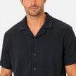 Men's lightweight textured shirt and shorts set by FJØRNA, casual summer outfit, worn by a man outdoors.