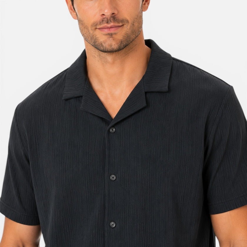 Men's lightweight textured shirt and shorts set by FJØRNA, casual summer outfit, worn by a man outdoors.