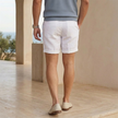 Men's lightweight cotton linen blend shorts by FJØRNA, relaxed fit with tailored style, shown in a casual outdoor setting.