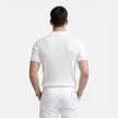 Men's ribbed knit polo shirt by FJØRNA, slim fit design in premium cotton, shown on a male model.
