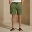 Men's textured summer shorts by FJØRNA with a relaxed fit and drawstring waist, shown in a casual outdoor setting.