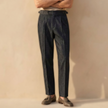 Men's high waist straight leg casual trousers by FJØRNA, showing the fit and tailored design in a neutral fabric.