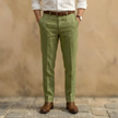 Men's linen blend pleated straight-leg trousers by FJØRNA, showing the tailored fit and classic waistband detail.