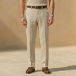 Men's linen blend straight leg trousers by FJØRNA featuring a pleated relaxed fit and classic design.