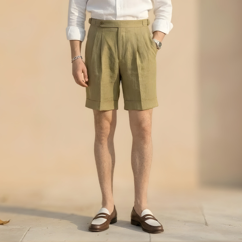 Men's high waist linen shorts by FJØRNA with pleated design and tailored fit, perfect for casual or smart summer wear.