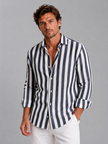 Men's striped linen-look shirt by FJØRNA featuring a relaxed summer button-up style, displayed on a male model in a casual setting.