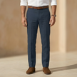Men's tailored linen blend straight leg trousers by FJØRNA, showing the classic fit and lightweight fabric in a neutral color.