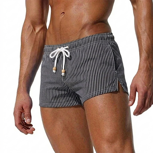 Men's striped swim shorts by FJØRNA with drawstring waist and quick-dry fabric, suitable for beach or poolside wear.