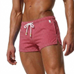 Men's FJØRNA striped swim shorts with drawstring waist and quick-dry fabric, suitable for beach and pool activities.