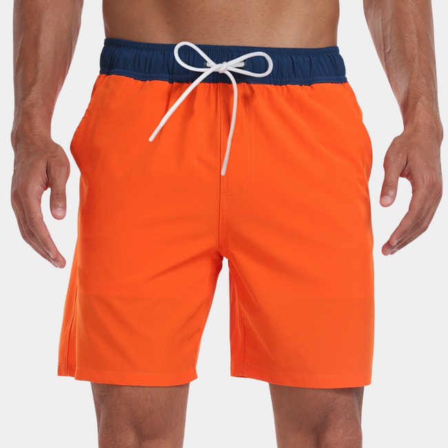Men's FJØRNA swim shorts with adjustable waistband and built-in compression liner, shown with a relaxed fit and vibrant color.