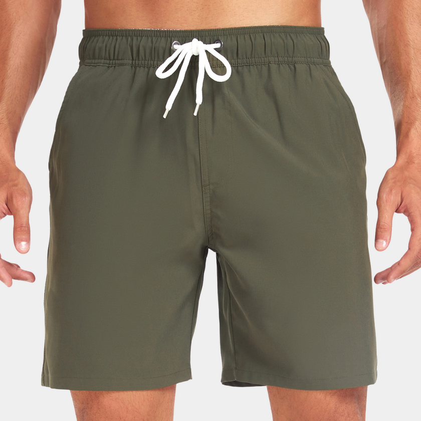 Men's FJØRNA swim shorts with adjustable waistband and built-in compression liner, shown with a lightweight, quick-drying fabric.