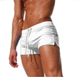 FJØRNA men's swim boxers with adjustable waistband and side split, featuring lightweight fabric and relaxed fit for beachwear.