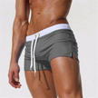 Men's FJØRNA swim boxers with adjustable waistband and side split, lightweight swim shorts for beach and pool activities.