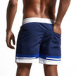 Men's FJØRNA colour block swim shorts with elasticated drawstring waist and contrast panels, suitable for beach or pool.