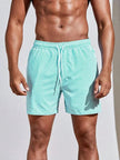 Men's FJØRNA pinstripe swim shorts with a drawstring waist, featuring a stylish striped pattern and comfortable fit.