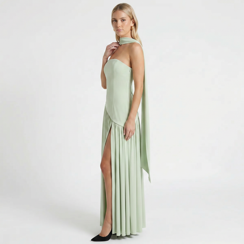 Mint green women's elegant strapless maxi dress by FJØRNA, side profile view showing flowing fabric and fitted bodice.