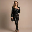 FJØRNA women's summer blouse with V-neck, long sleeves, and sequin embellishments, worn by a model showcasing the stylish top.