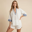 FJØRNA women's summer two-piece set featuring geometric pockets, styled on a model with a sleeveless crop top and matching shorts.