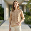 FJØRNA women's floral V-neck summer blouse worn by a model, lightweight top with a vibrant floral pattern and feminine style.