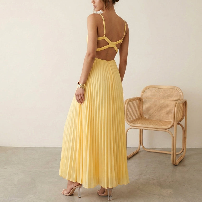 FJØRNA Eileen satin ruched bodice sleeveless maxi dress with pleated skirt worn by model, elegant evening gown with flowing design.