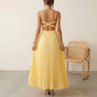 FJØRNA Eileen satin ruched bodice sleeveless maxi dress with pleated skirt, worn by model showcasing elegant evening style