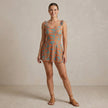 Model wearing FJØRNA summer ruffle floral swimsuit for women, featuring a vibrant, floral design with ruffled details.