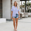 FJØRNA women's summer blouse with striped linen fabric, button front and casual fit worn by a model.