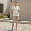 FJØRNA women's summer blouse featuring short sleeves and an asymmetric linen design, worn by a model.