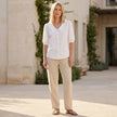 FJØRNA women's summer blouse featuring puff sleeves, linen fabric, and button-front design modeled on a woman.
